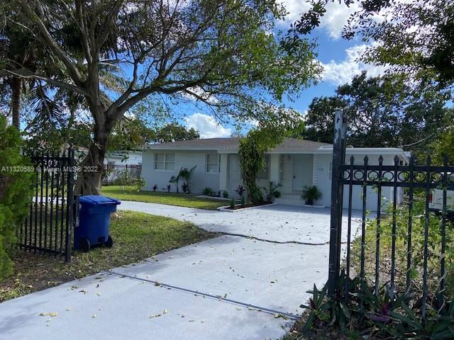 Biscayne Gardens Miami, FL 33169 - Photo 6 of 18 a front view of a house with a garden