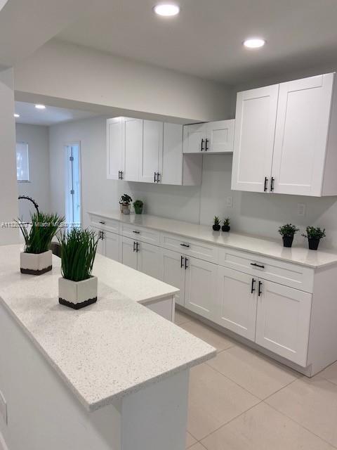 Biscayne Gardens Miami, FL 33169 - Photo 8 of 18 a kitchen with kitchen island white cabinets and white appliances