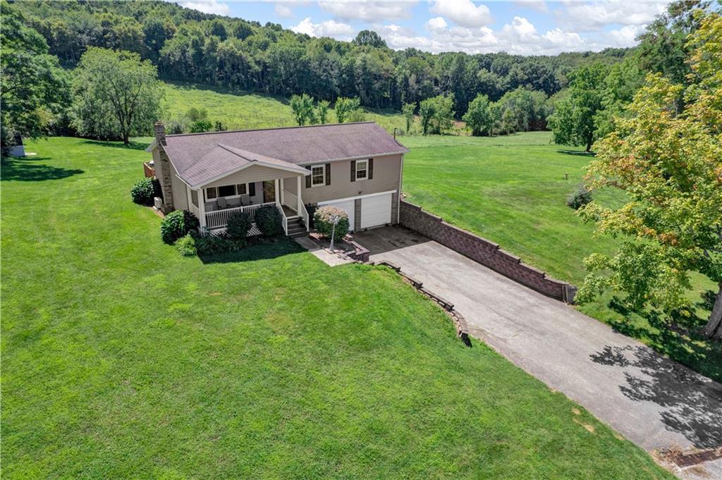 180 Swearingen Road Georgetown, PA 15043 - Photo 2 of 20 a view of a house with a big yard potted plants and large tree