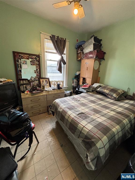 564 River Street Paterson, NJ 07524 - Photo 8 of 23 a bedroom with a bed and a chandelier