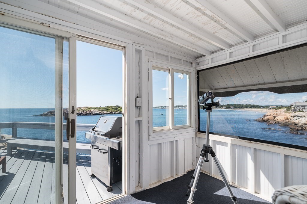 45 Salt Island Road Gloucester, MA 01930 - Photo 11 of 42 a bedroom with a bed and a balcony view