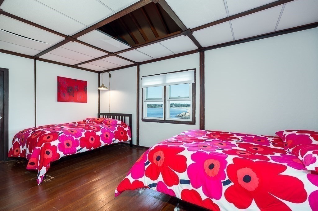 45 Salt Island Road Gloucester, MA 01930 - Photo 20 of 42 a bedroom with a bed and a lamp