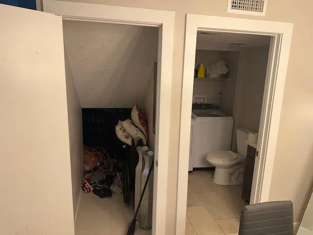 a white toilet sitting next to a shower curtain