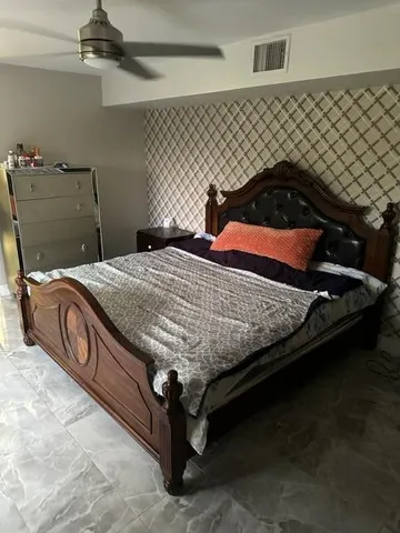 a view of a pathway with a fountain in the background