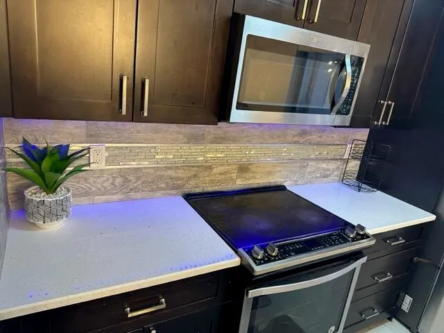 a kitchen with a table chairs and refrigerator