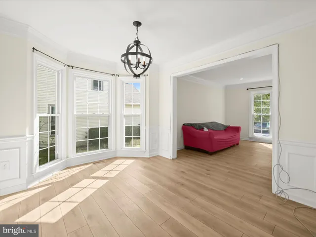 a view of a livingroom with furniture window and hardwood floor
