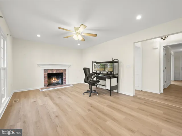a view of a livingroom with a fireplace and a chandelier