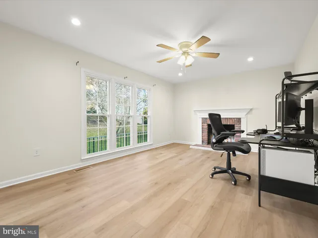 a view of a workspace with furniture and a window