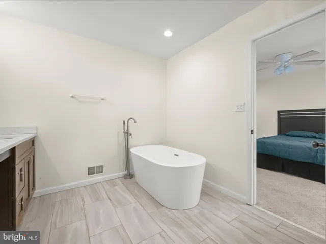 a spacious bedroom with a bed and a window