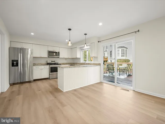 a kitchen with stainless steel appliances a refrigerator and a stove top oven
