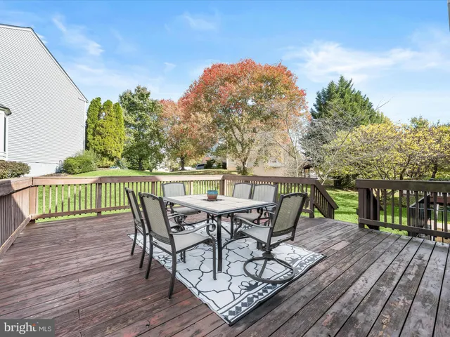 a view of a house with a yard and deck