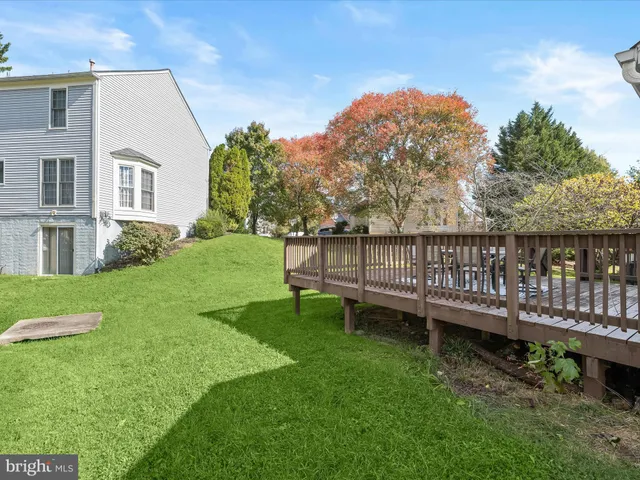 a view of a chair and table in backyard of the house