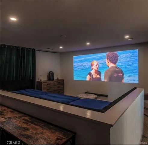 a room with stainless steel appliances wooden floor and large window