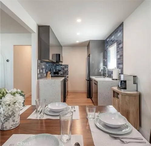 a living room with furniture and a view of kitchen