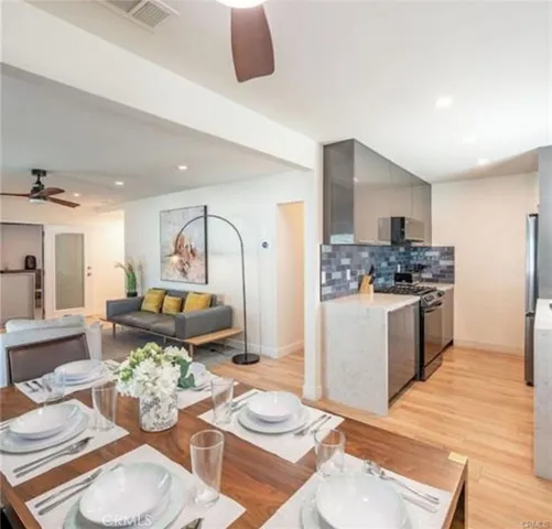 a living room with furniture and a view of kitchen