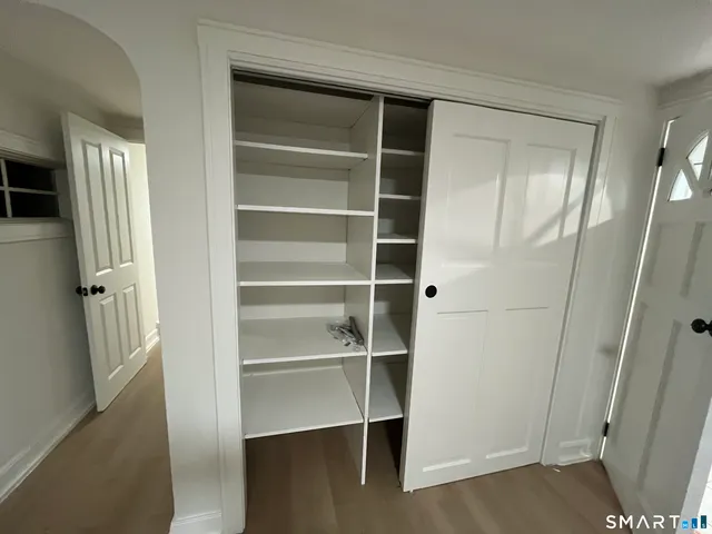 a view of walk in closet with empty racks