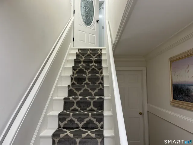 a view of a hallway with wooden floor and entryway