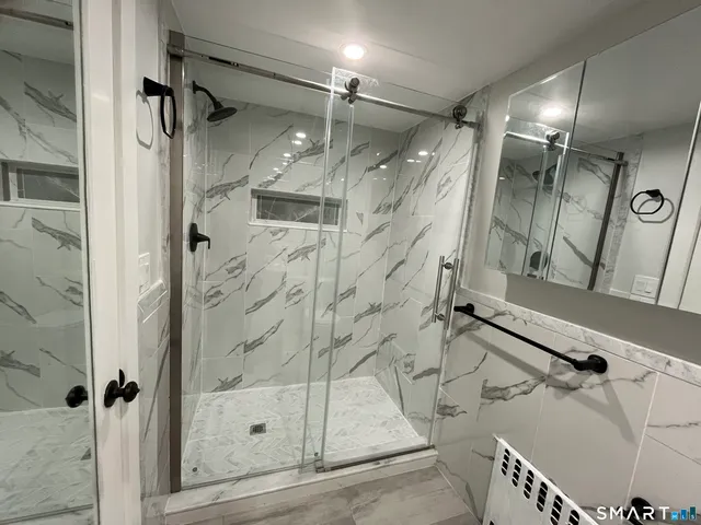 a bathroom with a glass shower door