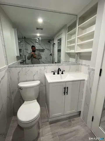 a bathroom with a sink toilet and shower