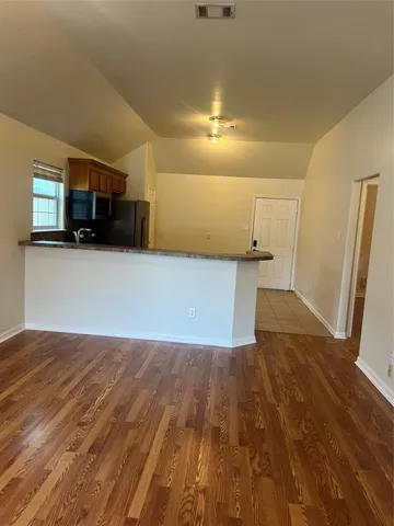 a view of a livingroom with wooden floor