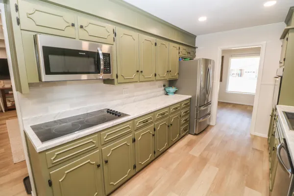 a spacious bathroom with a granite countertop sink and a mirror