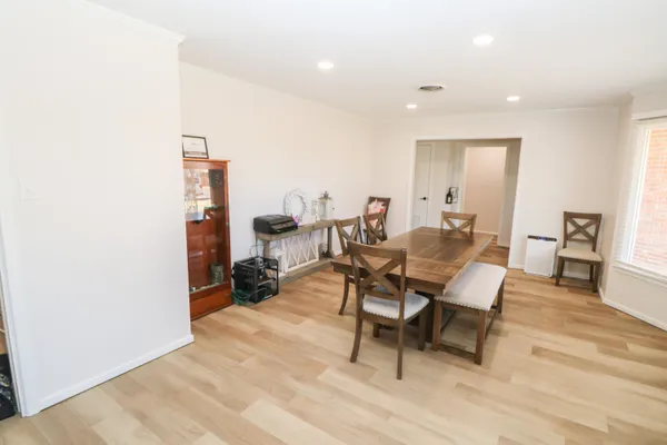 a dining room with furniture and wooden floor