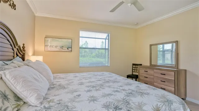 a bedroom with a bed dresser and a window
