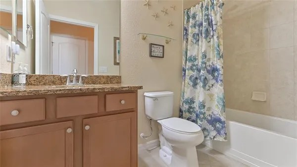 a bathroom with a granite countertop toilet sink and shower
