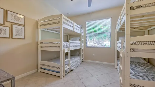 a bedroom with a bunk bed and a window