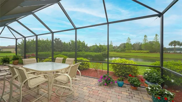 a view of a porch with a table chairs and a potted plant