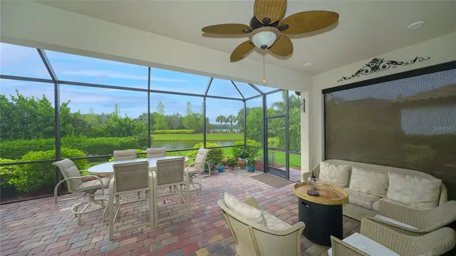 a living room with patio furniture and garden