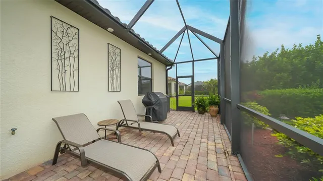 a balcony with table and chairs