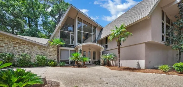a front view of a house with plants