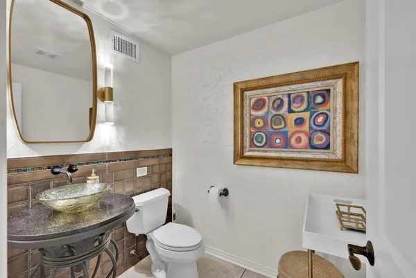 a kitchen with stainless steel appliances granite countertop a stove white cabinets a sink and dishwasher
