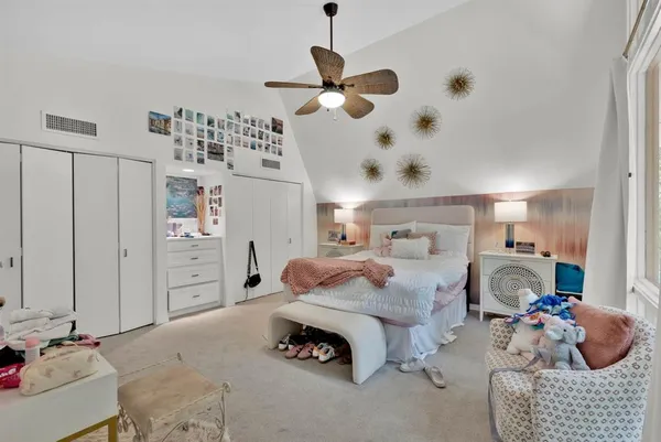 a bedroom with a large bed and a chandelier