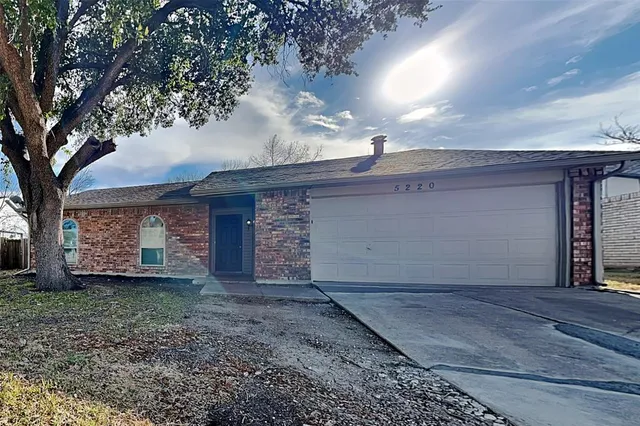 a view of a house with a yard and garage