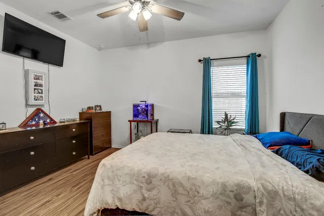 a bedroom with a bed and a flat screen tv