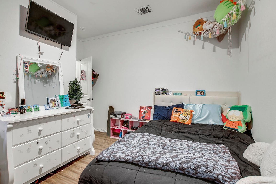 207 Soapstone Pass Maxwell, TX 78656 - Photo 21 of 30 a bedroom with a bed and wooden floor