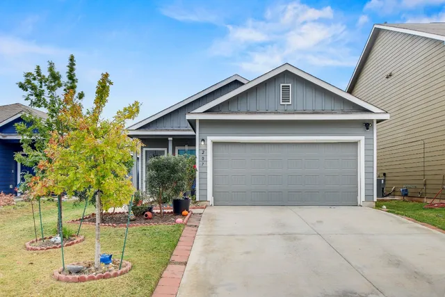 a front view of a house with garden
