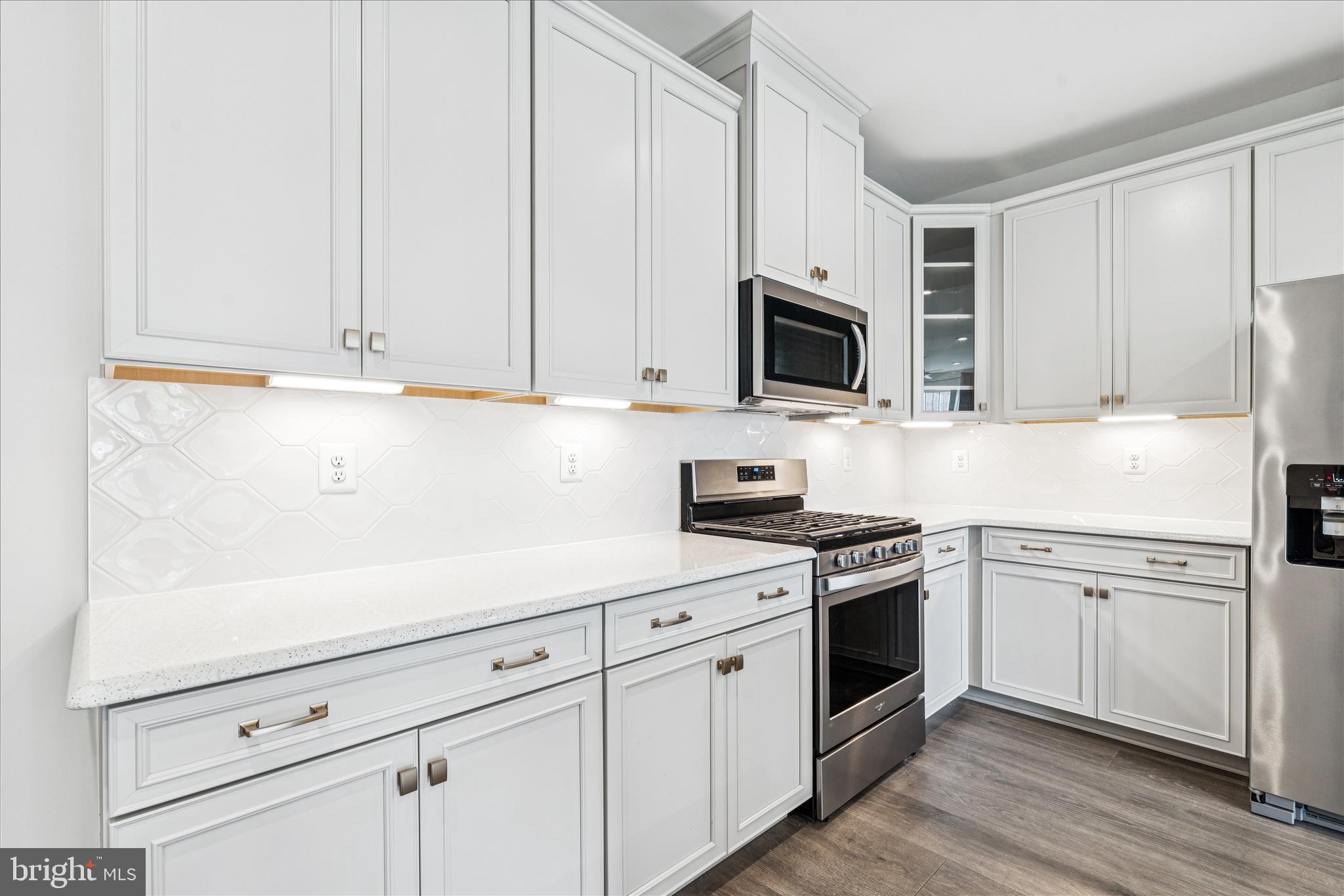 9454 James Macgowan Lane, Unit 447 Owings Mills, MD 21117 - Photo 11 of 41 a kitchen with white cabinets and white appliances