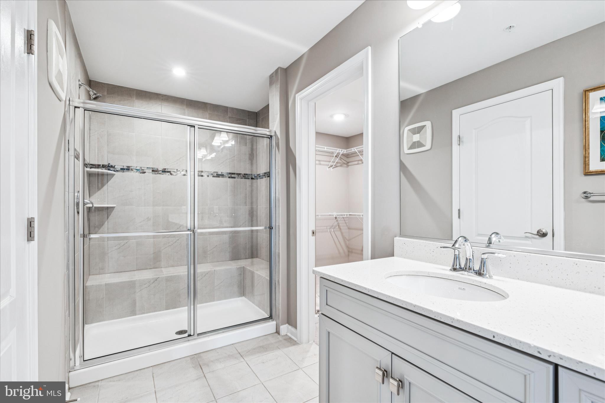9454 James Macgowan Lane, Unit 447 Owings Mills, MD 21117 - Photo 19 of 41 a bathroom with a shower sink and mirror