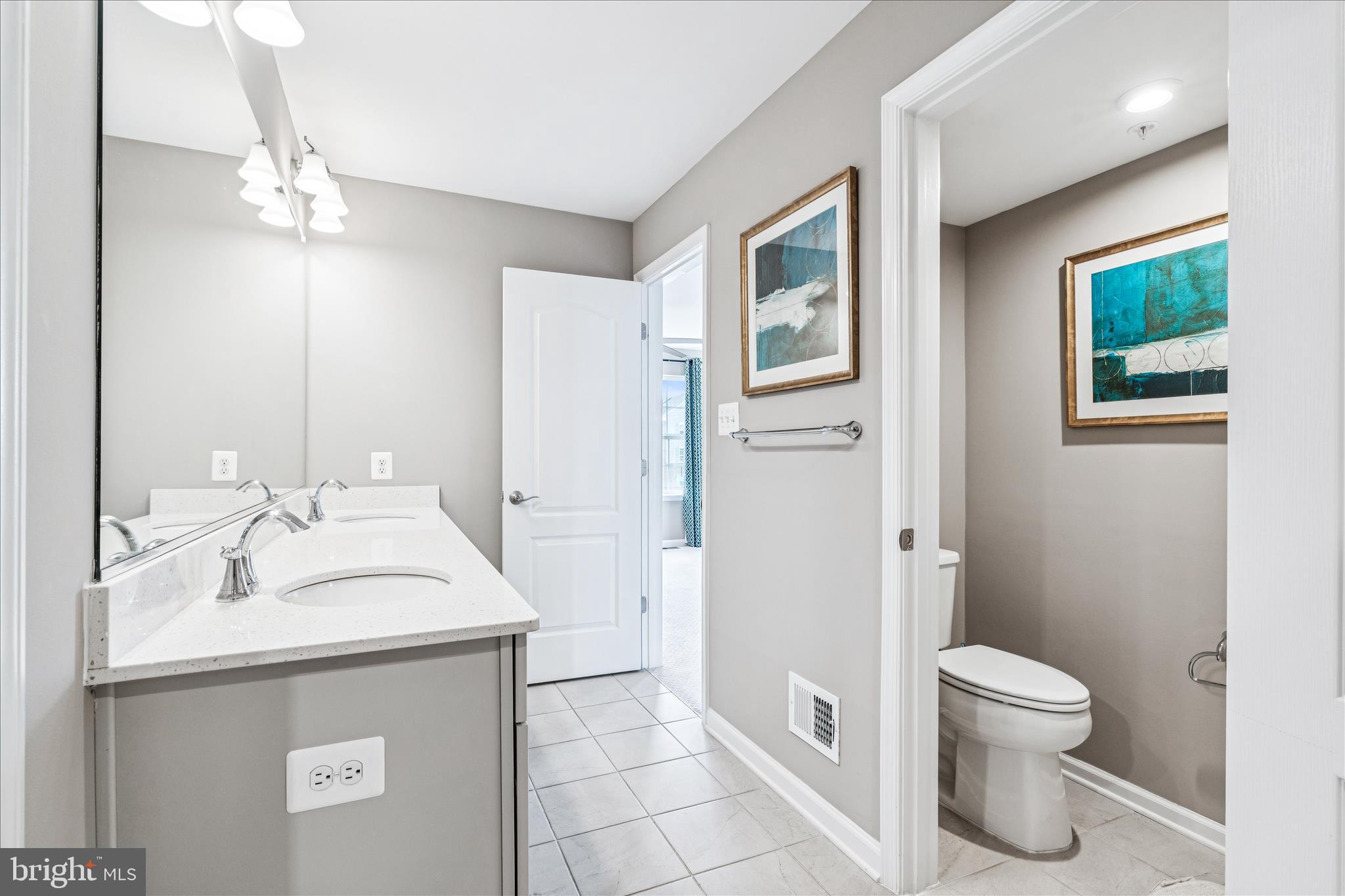 9454 James Macgowan Lane, Unit 447 Owings Mills, MD 21117 - Photo 20 of 41 a bathroom with a toilet sink and mirror