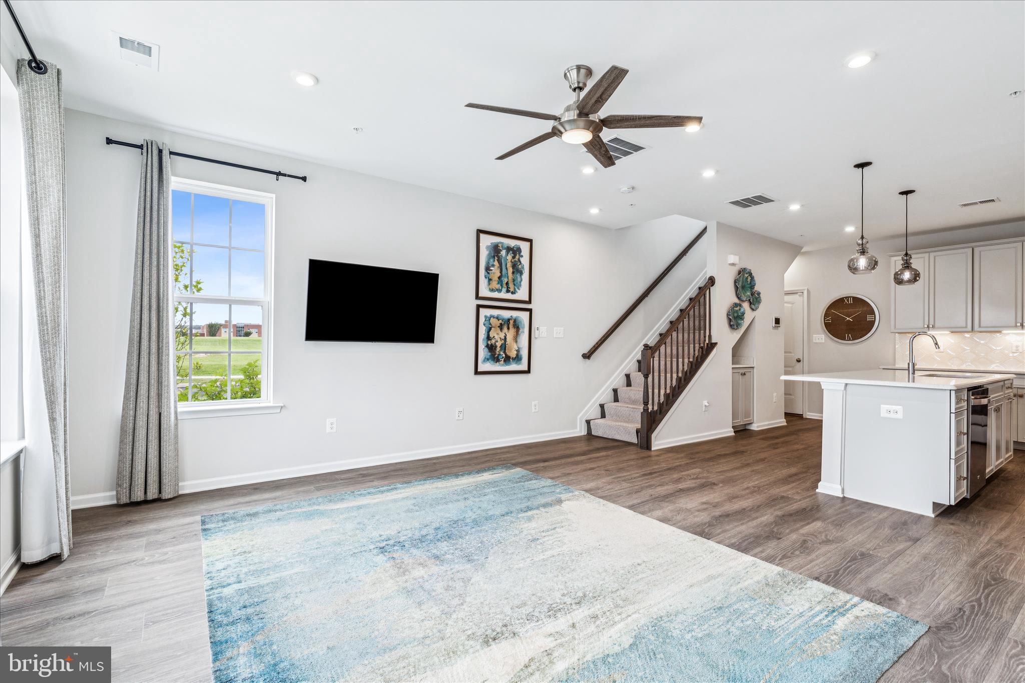 9454 James Macgowan Lane, Unit 447 Owings Mills, MD 21117 - Photo 2 of 41 a view of a livingroom with an empty space and a ceiling fan