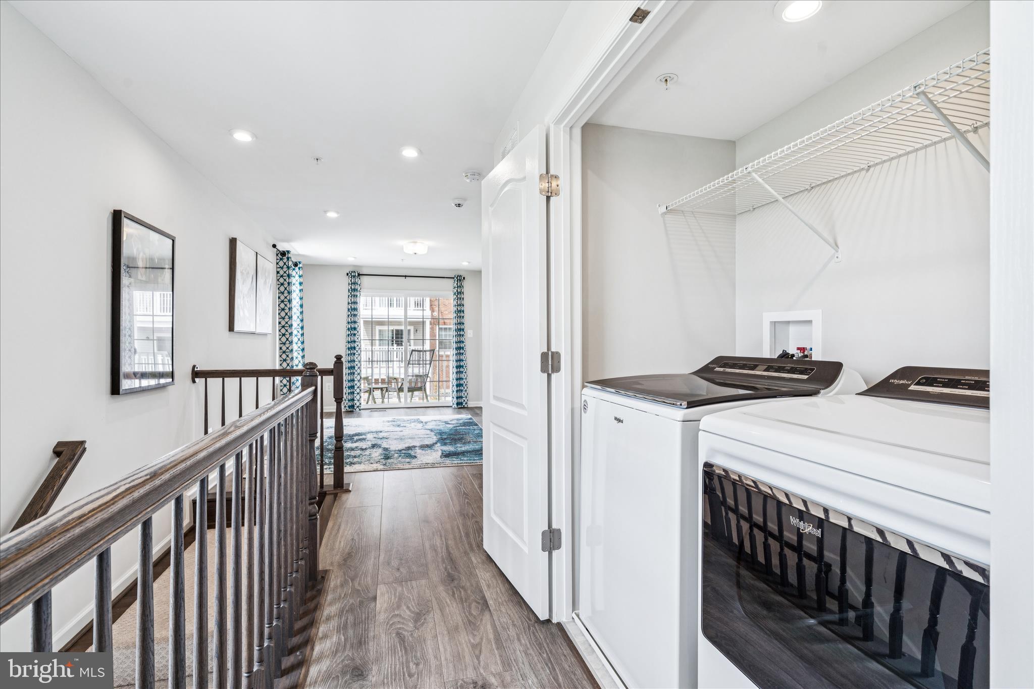 9454 James Macgowan Lane, Unit 447 Owings Mills, MD 21117 - Photo 21 of 41 a view of a hallway with wooden floor and staircase