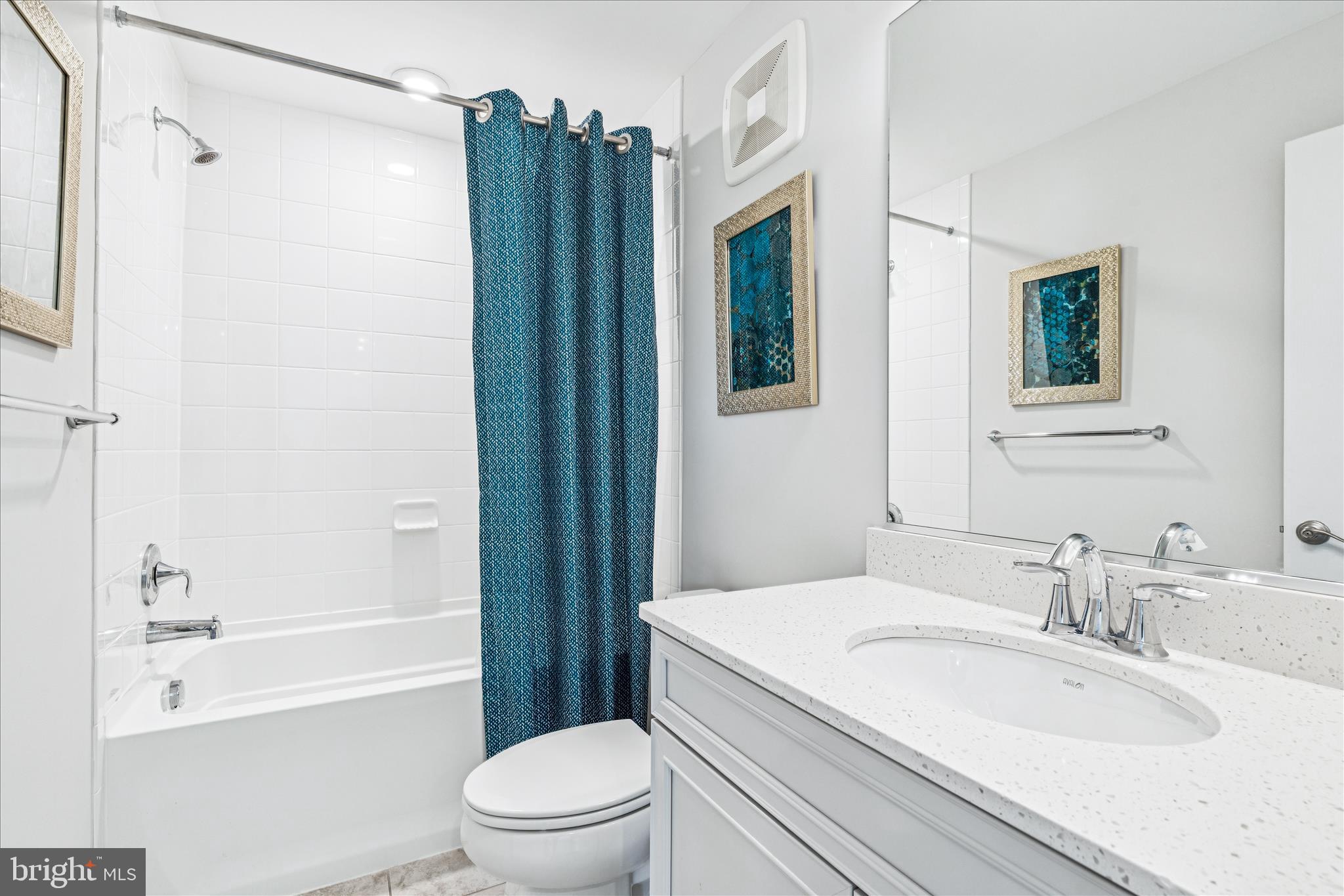 9454 James Macgowan Lane, Unit 447 Owings Mills, MD 21117 - Photo 24 of 41 a bathroom with a granite countertop sink toilet and shower