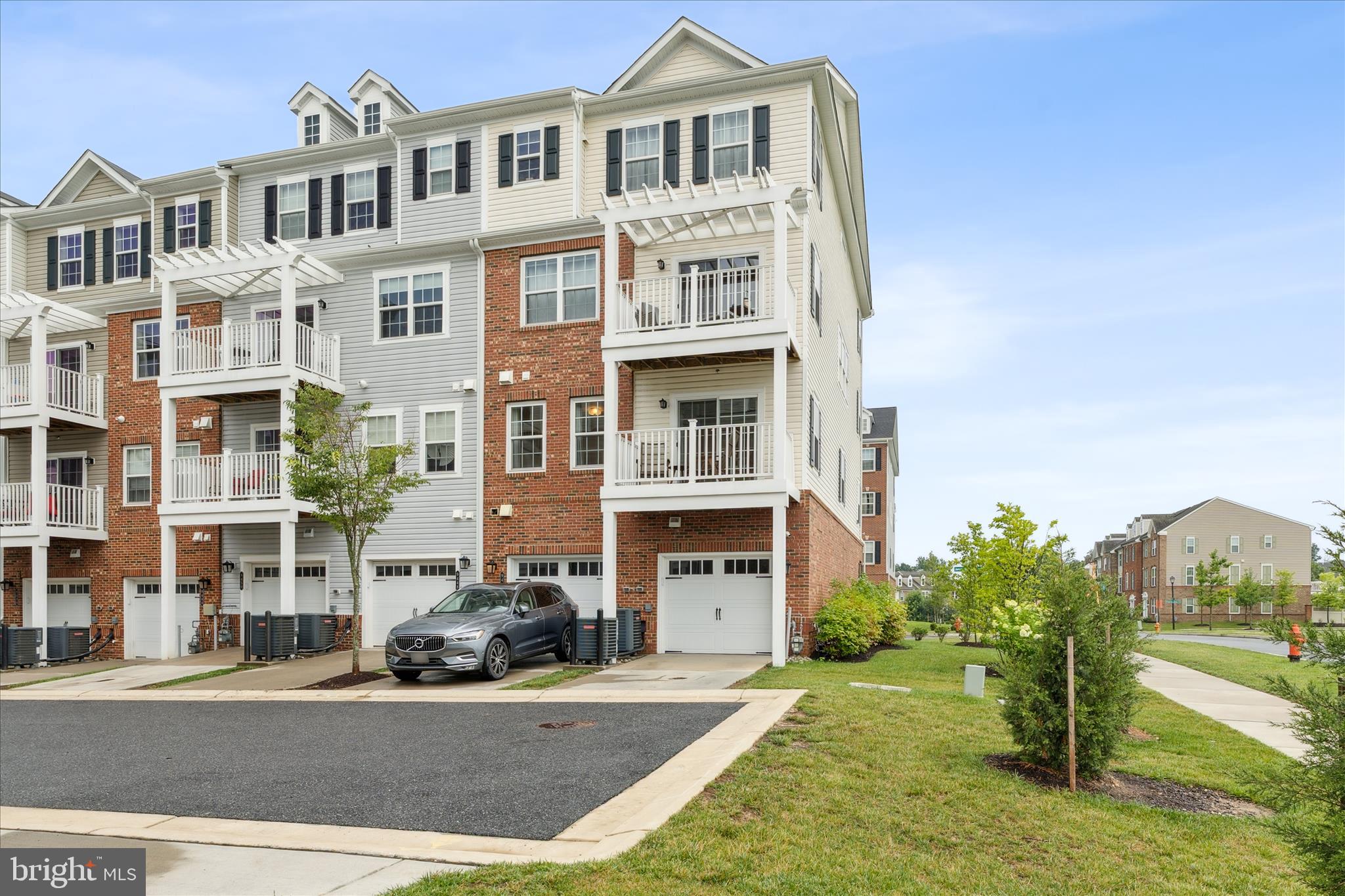 9454 James Macgowan Lane, Unit 447 Owings Mills, MD 21117 - Photo 27 of 41 a front view of a residential apartment building with a yard