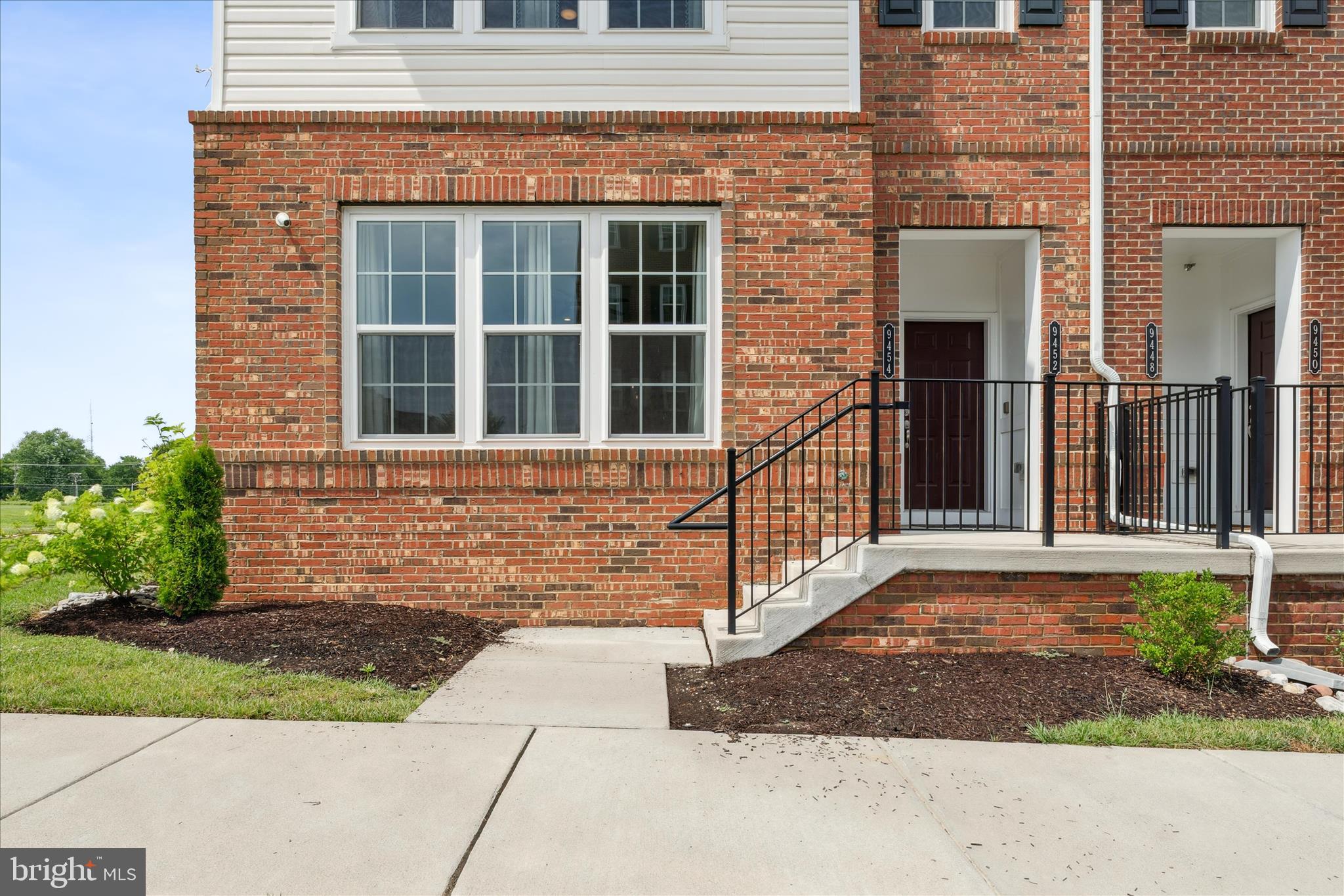 9454 James Macgowan Lane, Unit 447 Owings Mills, MD 21117 - Photo 39 of 41 a front view of a house with a yard