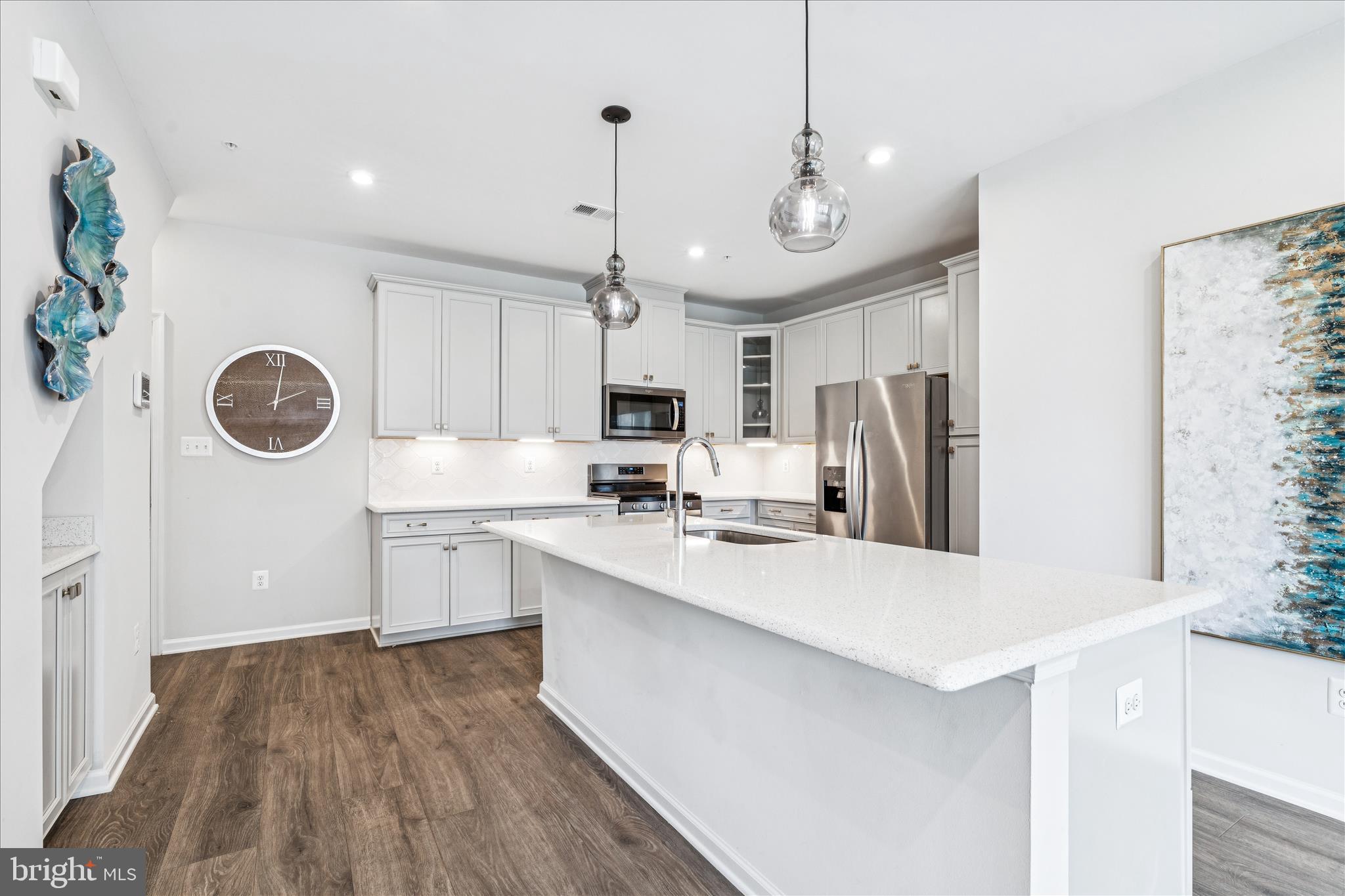 9454 James Macgowan Lane, Unit 447 Owings Mills, MD 21117 - Photo 7 of 41 a large kitchen with stainless steel appliances a stove a refrigerator and a kitchen island