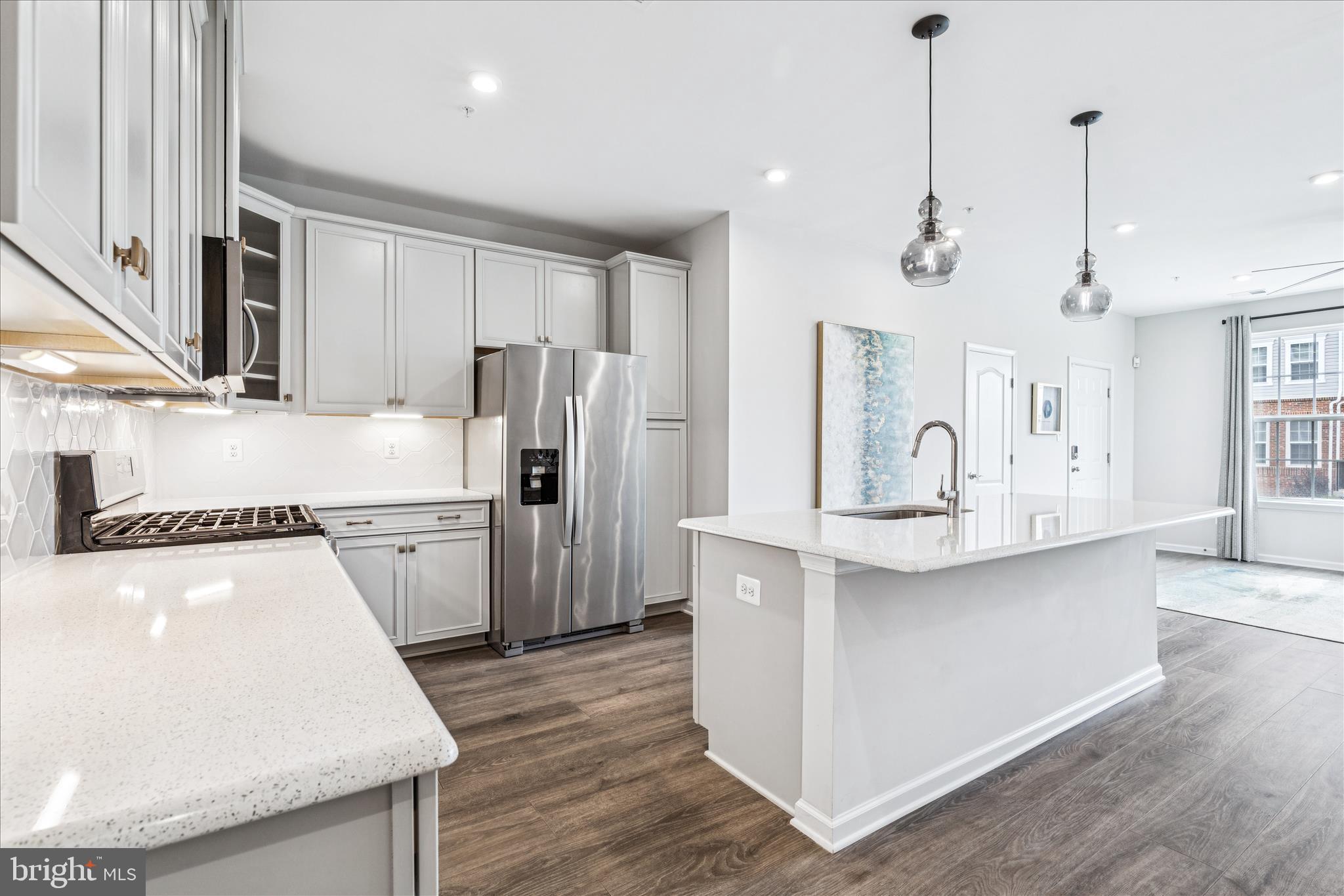 9454 James Macgowan Lane, Unit 447 Owings Mills, MD 21117 - Photo 9 of 41 a kitchen with refrigerator cabinets and wooden floor