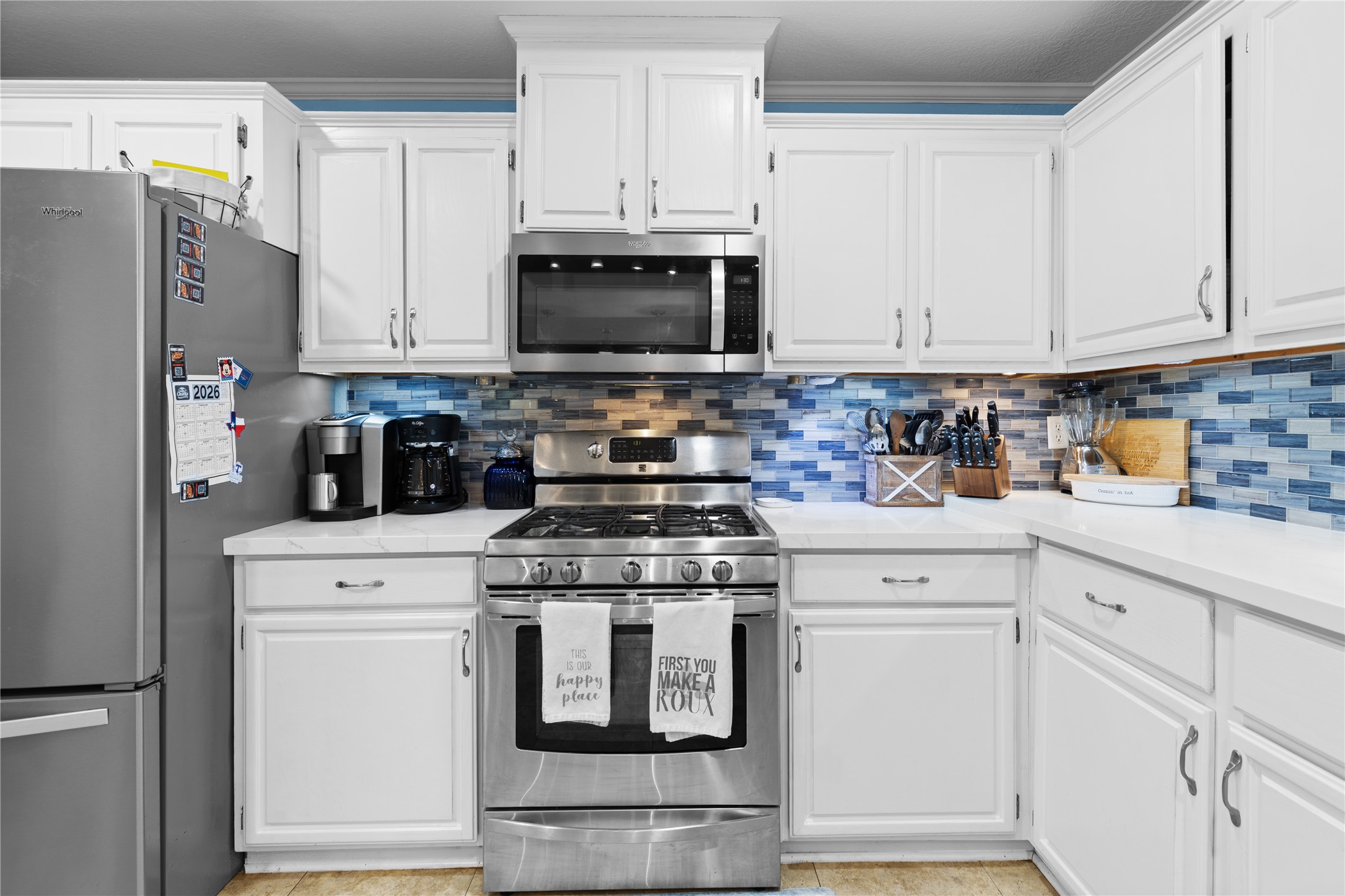 174 Lake Front Drive Trinity, TX 75862 - Photo 8 of 44 a kitchen with white cabinets and stainless steel appliances